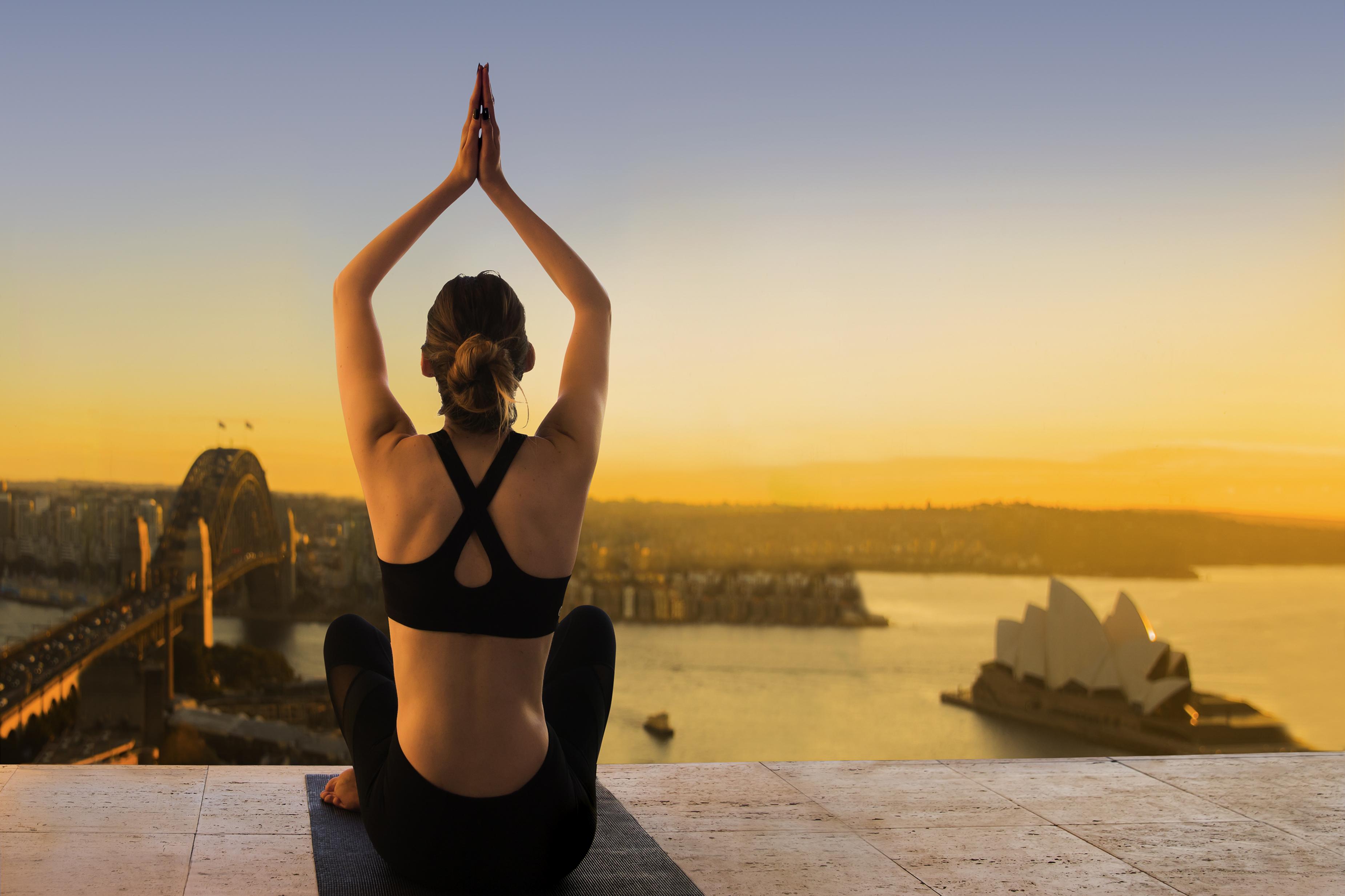 The Sebel Quay West Suites Sydney Bagian luar foto A woman practicing yoga at the Sydney Opera House